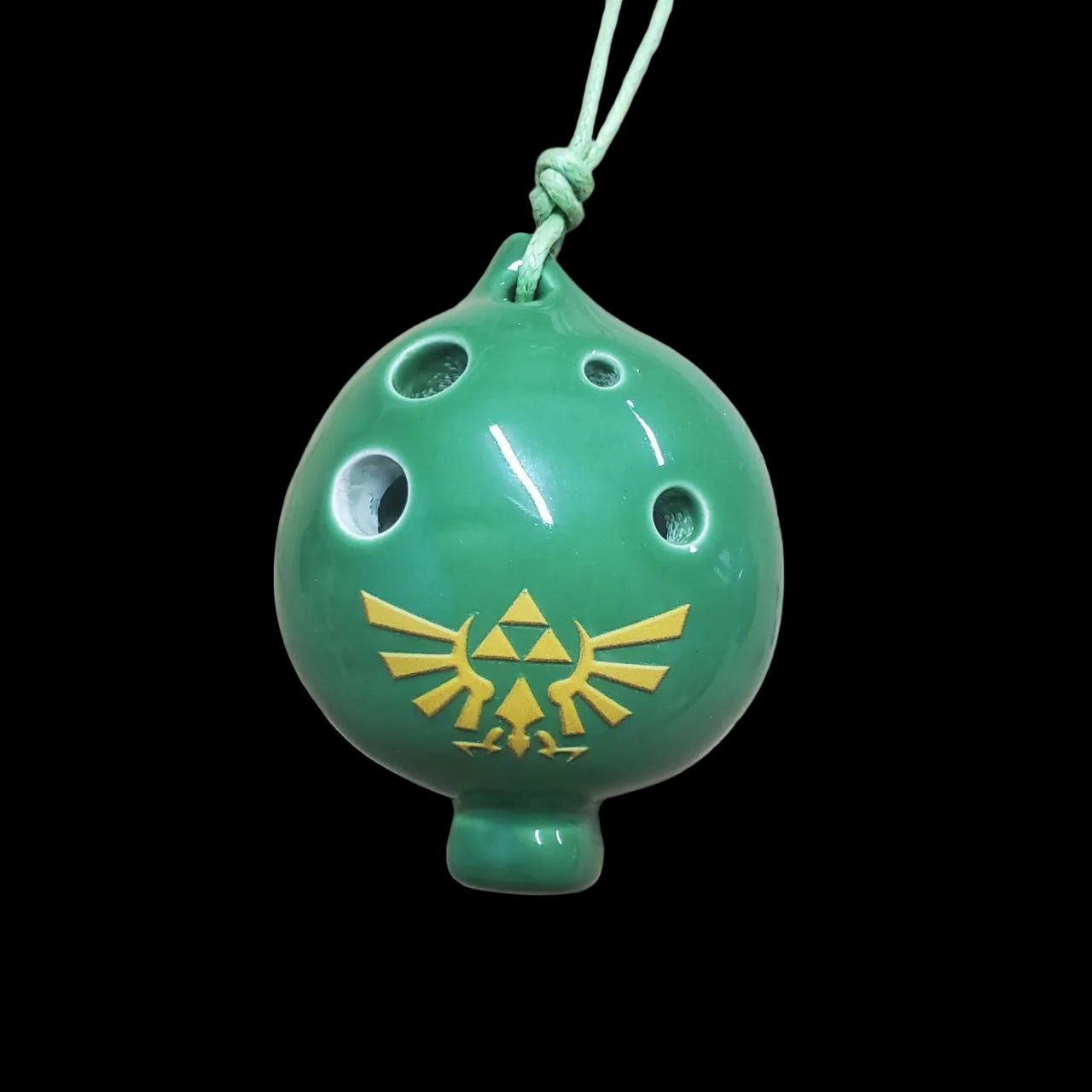 green 4-hole royal spade ocarina featuring a hylian crest from Zelda