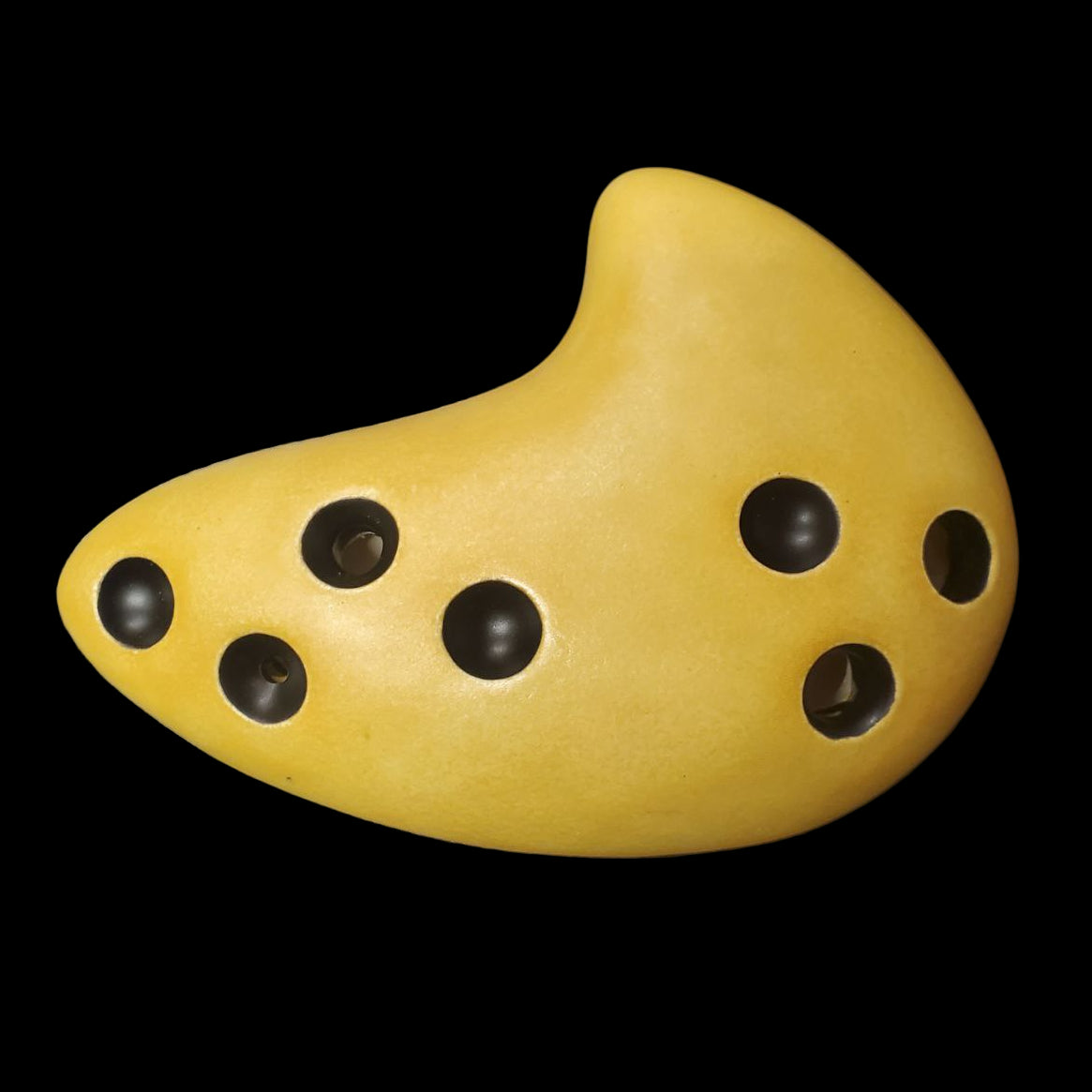 light brown 6-hole ocarina of awakening on a black background