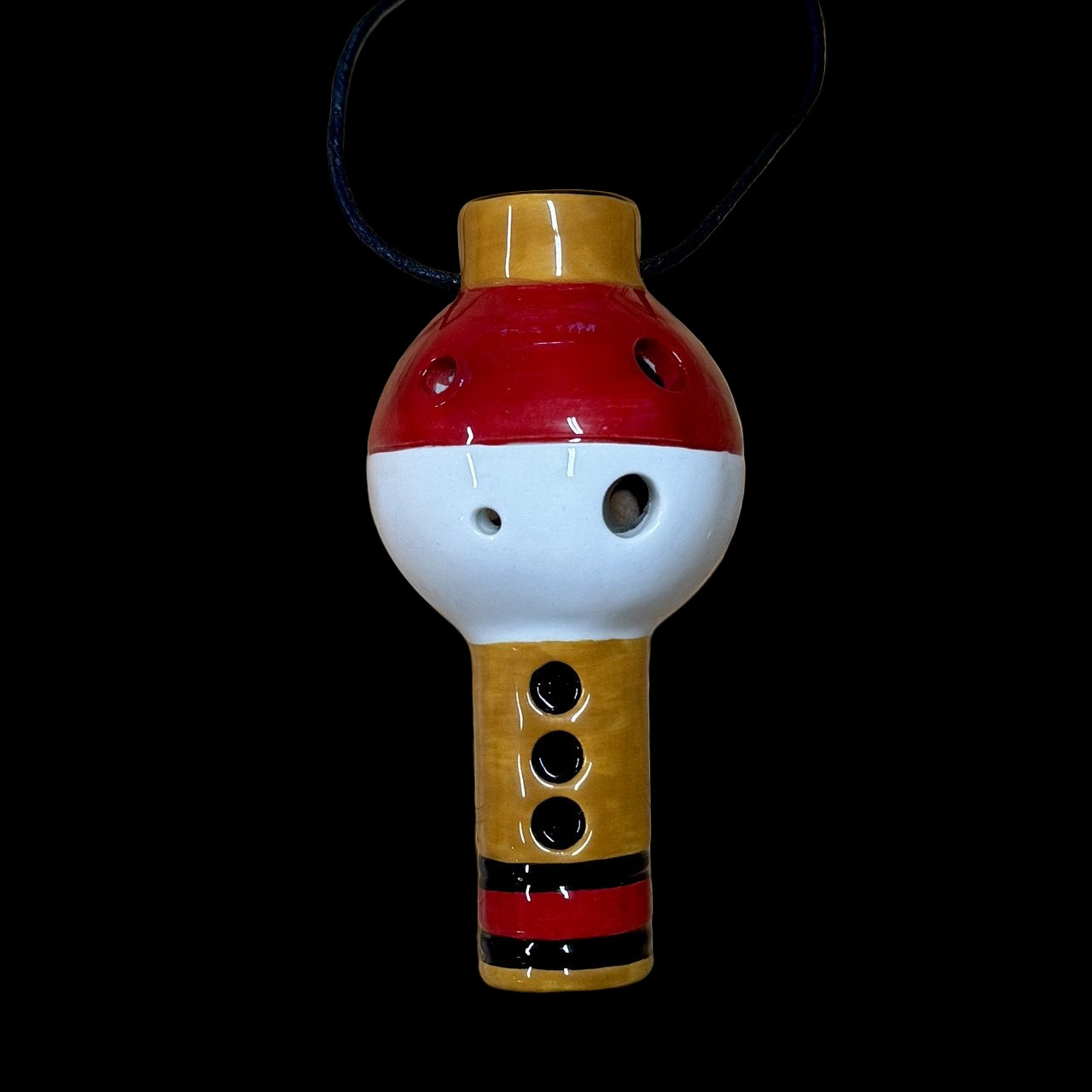 light brown, red and white pikaflute 6-hole ocarina pokeflute replica on a black background